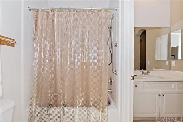 a bedroom with a bed and a lamp