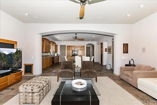 a living room with furniture a rug and a chandelier