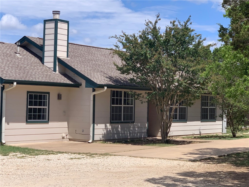a house that has a tree in front of it