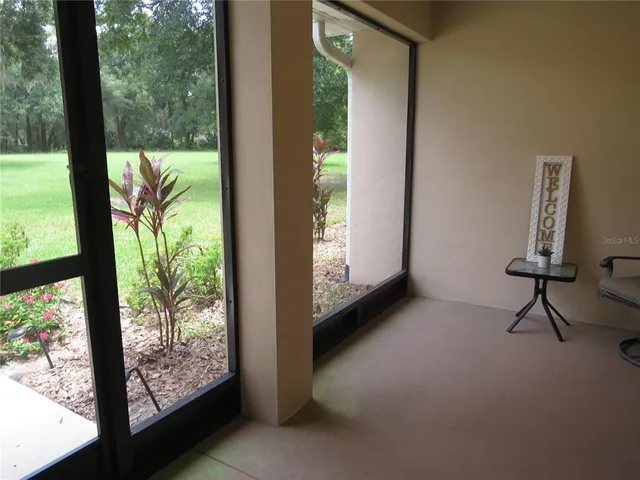 a kitchen with stainless steel appliances a sink dishwasher a refrigerator and white cabinets with wooden floor