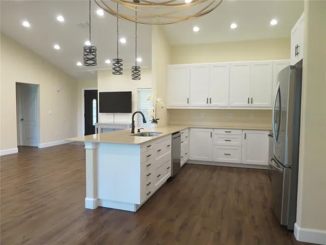 a view of a room with wooden floor and a window