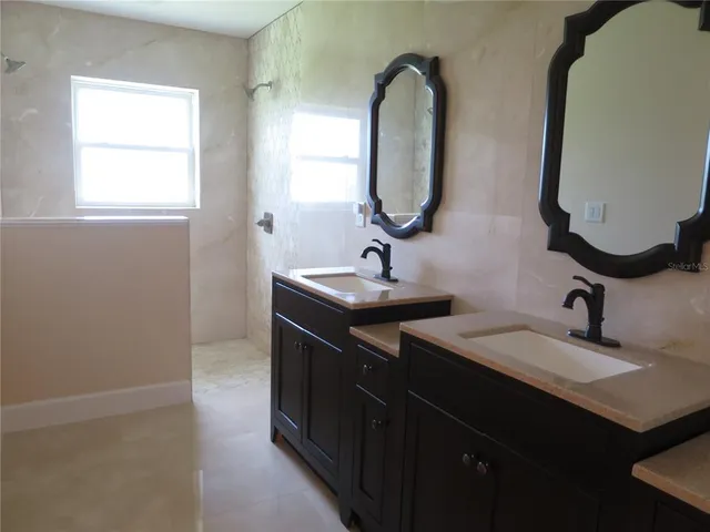a view of a room with wooden floor and a window