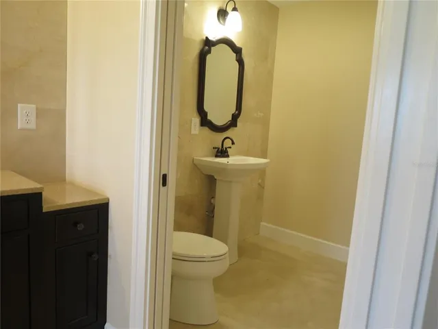 an empty room with wooden floor and closet area