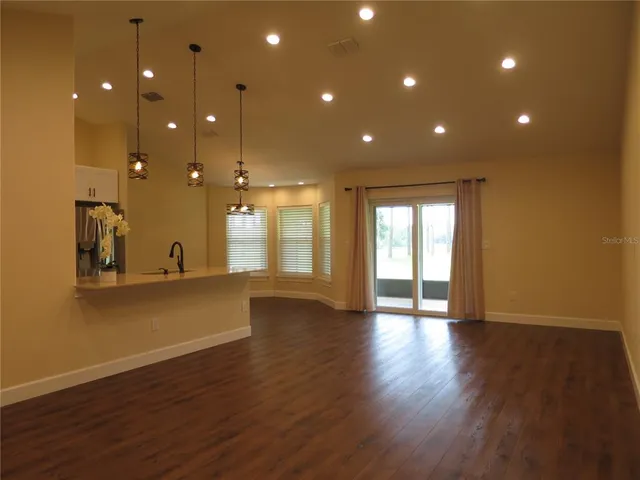 a bathroom with a granite countertop sink a toilet and a mirror