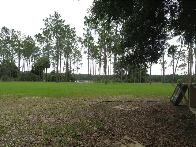 a front view of a house with a garden and yard