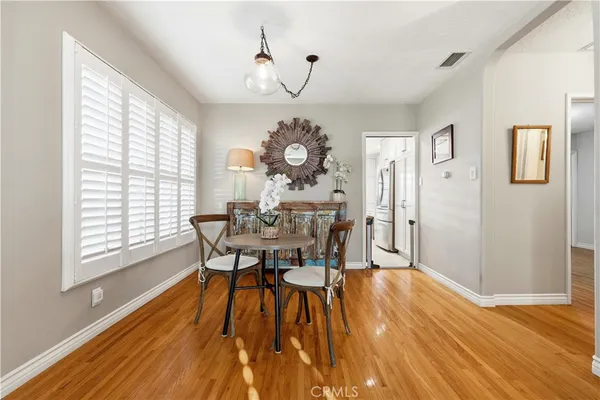 a view of a dining room with furniture window and wooden floor