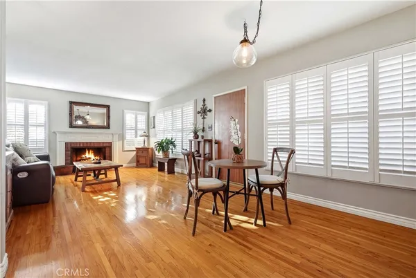 a view of a livingroom with furniture a fireplace and wooden floor