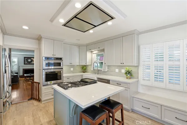 a kitchen with a stove a refrigerator and a sink