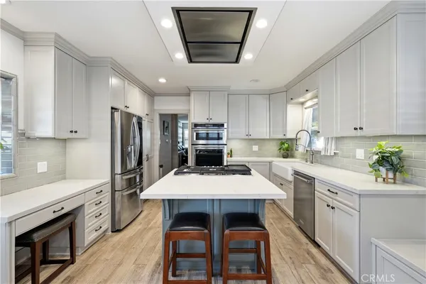 a kitchen with granite countertop a center island stainless steel appliances and cabinets