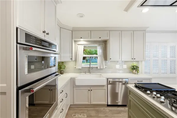 a kitchen with stainless steel appliances a stove sink and cabinets