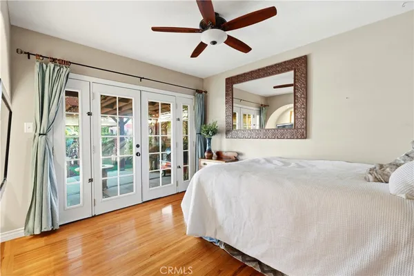 a bedroom with a large bed and a large window