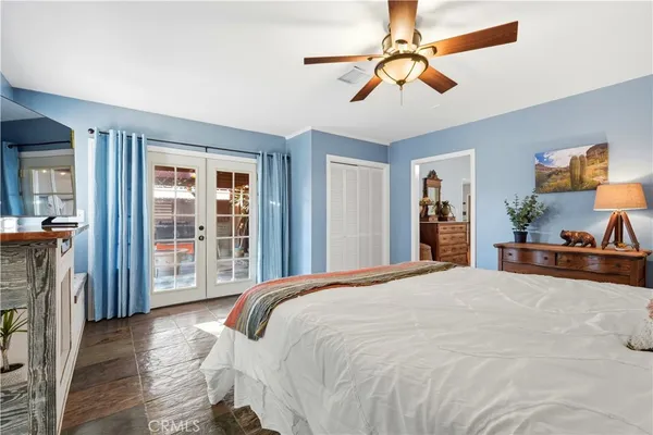 a bedroom with a large bed and a chandelier
