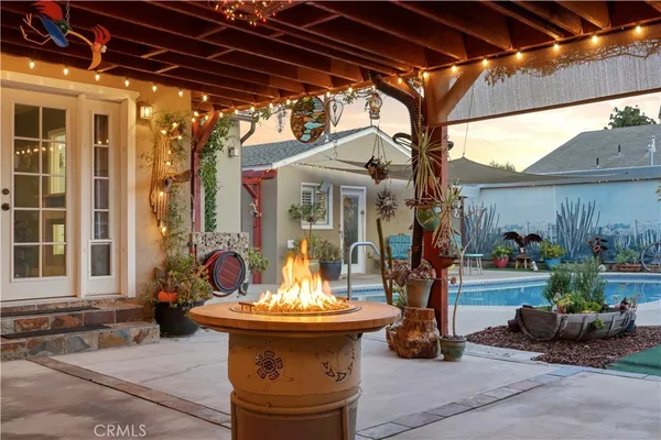 a view of a porch with furniture and a yard