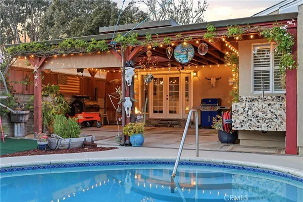 a view of a swimming pool with an outdoor seating