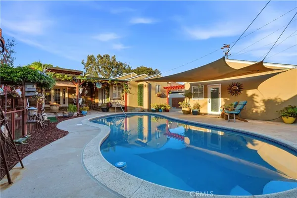a view of swimming pool with seating area