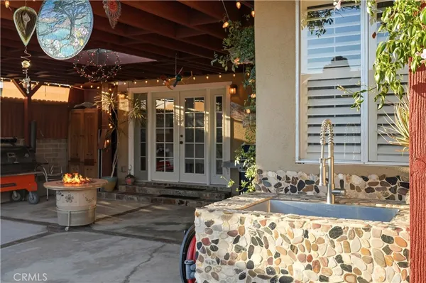 a view of a patio with table and chairs potted plants