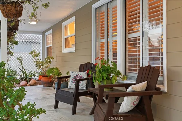 a outdoor living room with furniture and a potted plant