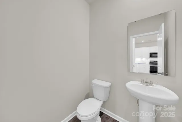 a bathroom with a sink a toilet and mirror