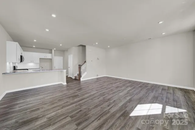 a view of kitchen with kitchen island sink and wooden floor