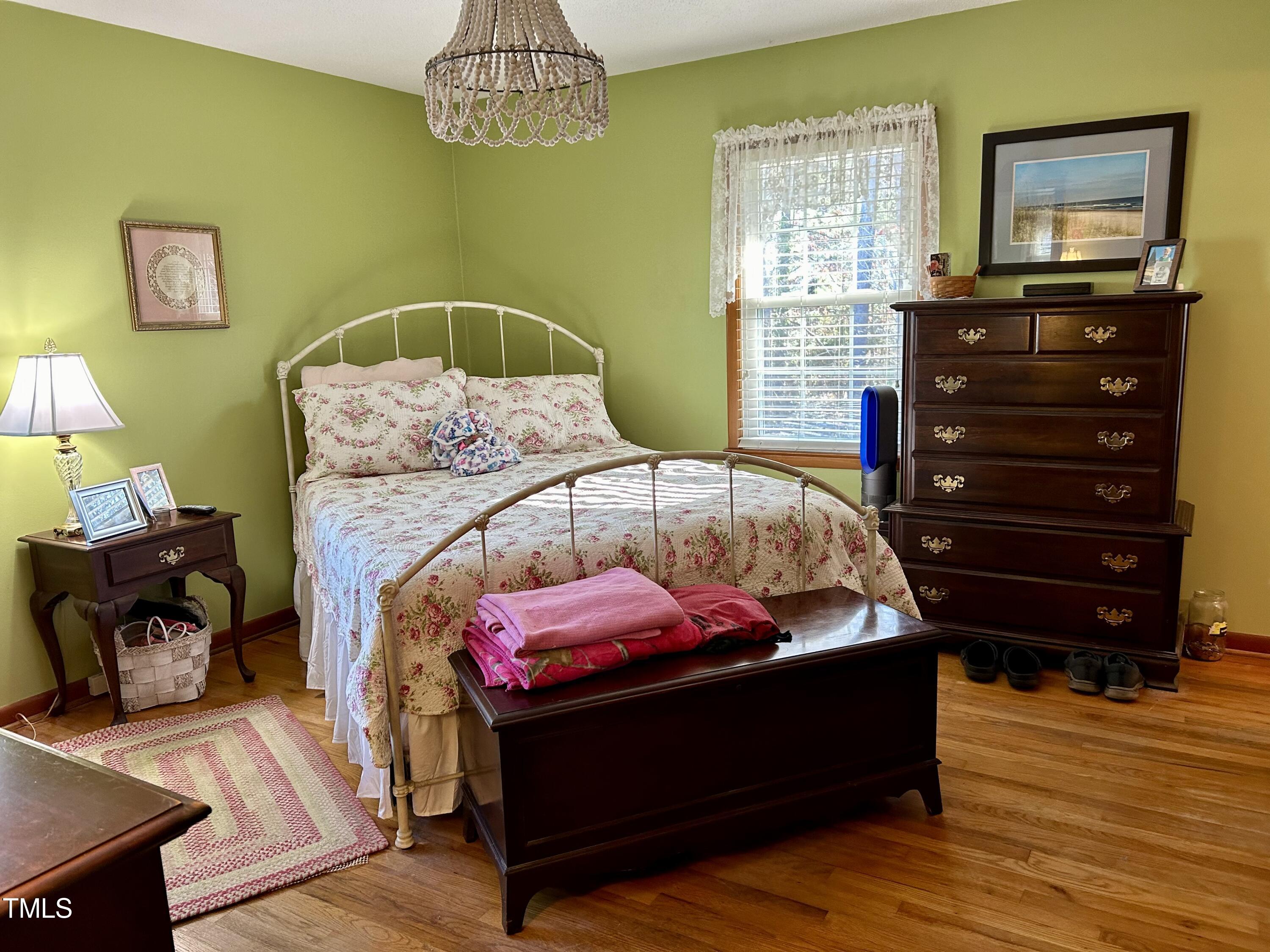 1320 North King Charles Road Raleigh, NC 27610 - Photo 12 of 21 a bedroom with a bed and wooden floor