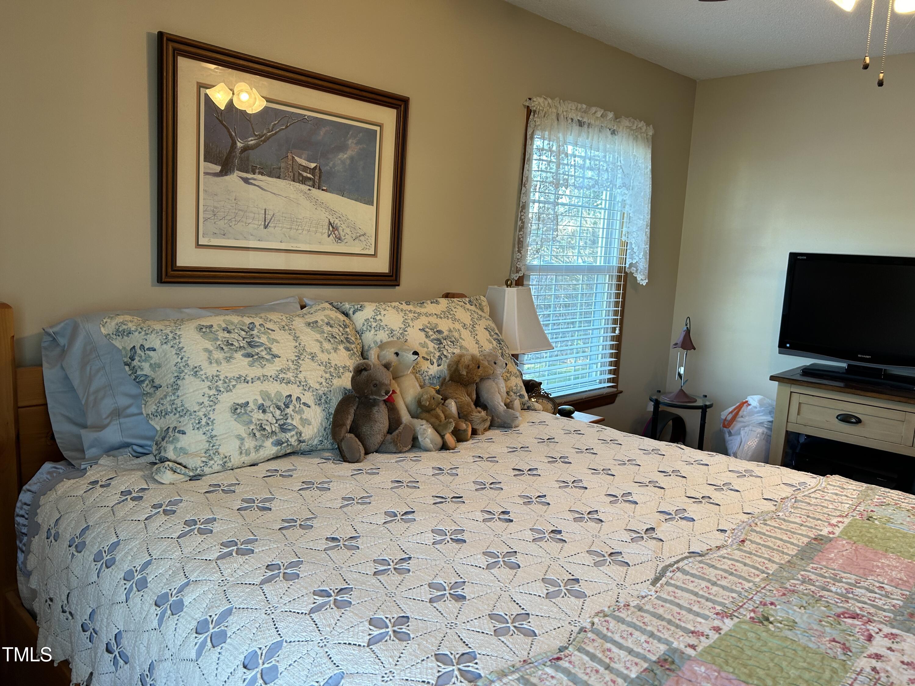 1320 North King Charles Road Raleigh, NC 27610 - Photo 14 of 21 a bedroom with a bed and a flat screen tv