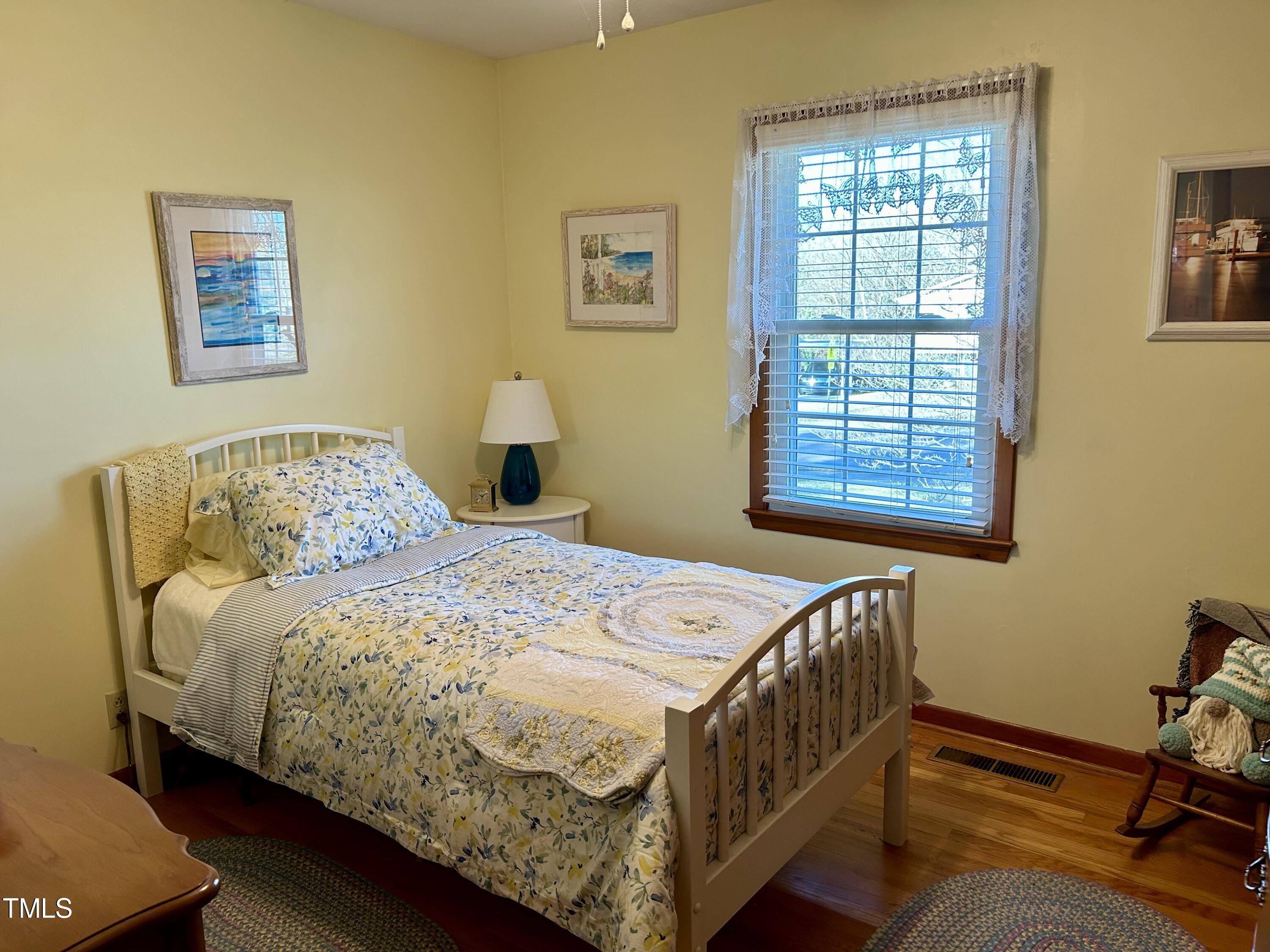 1320 North King Charles Road Raleigh, NC 27610 - Photo 15 of 21 a bedroom with a bed a dresser and next to a window