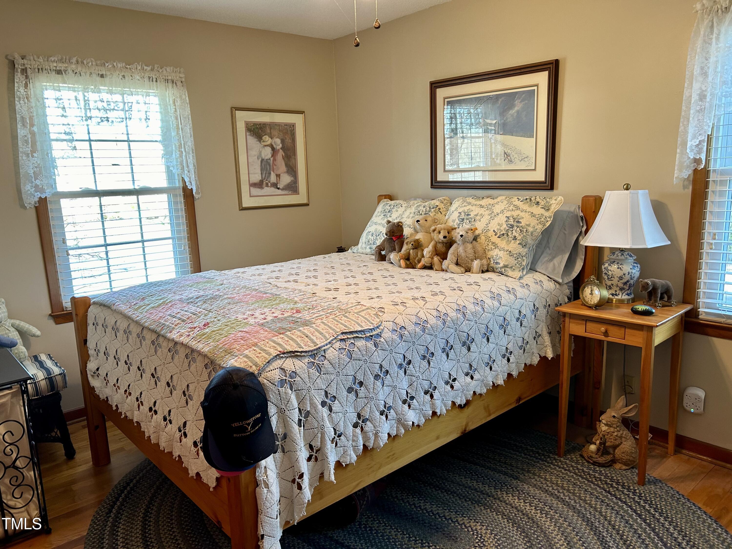 1320 North King Charles Road Raleigh, NC 27610 - Photo 16 of 21 a bed sitting in a bedroom next to a window