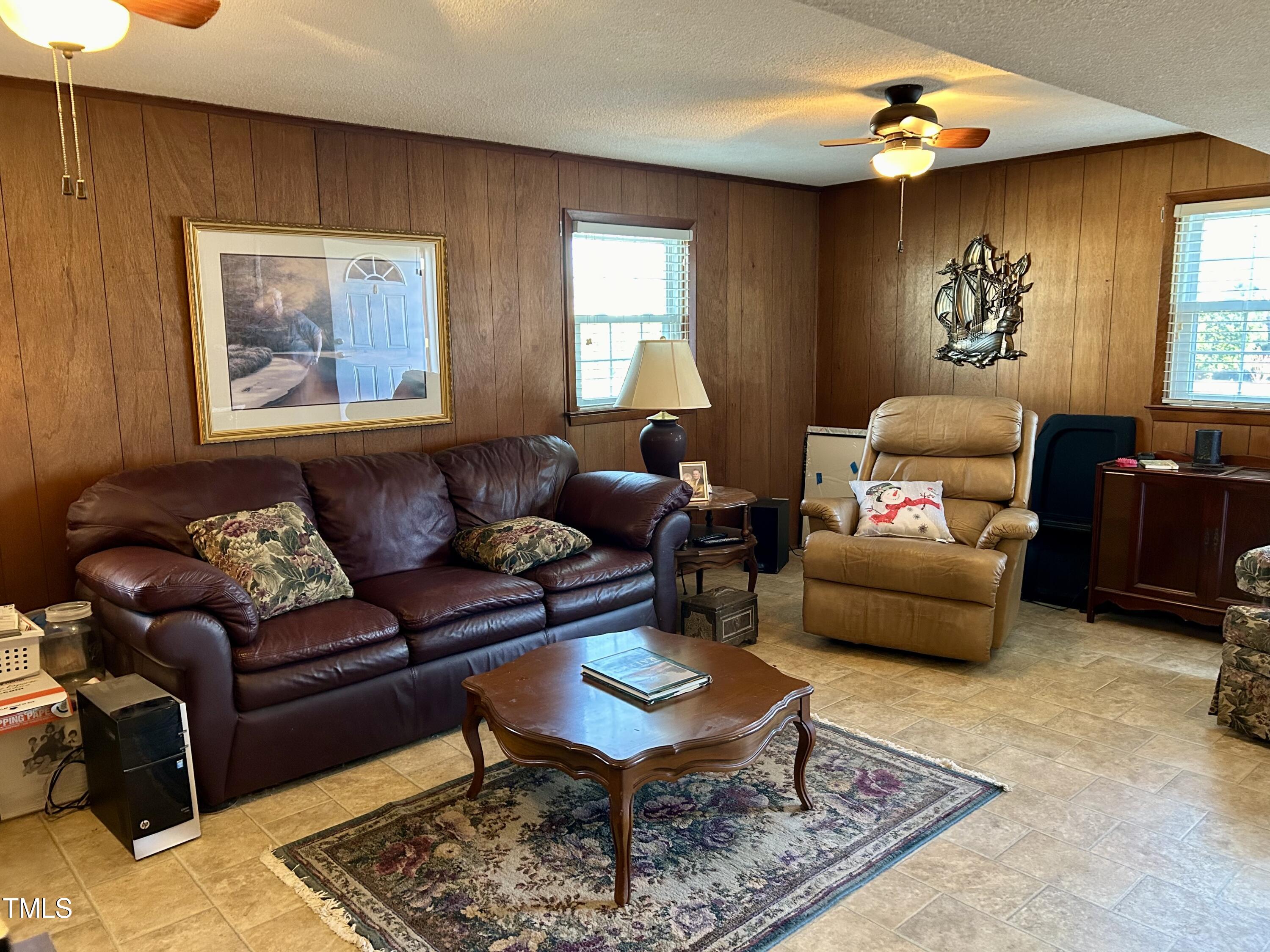 1320 North King Charles Road Raleigh, NC 27610 - Photo 20 of 21 a living room with furniture a rug and a window