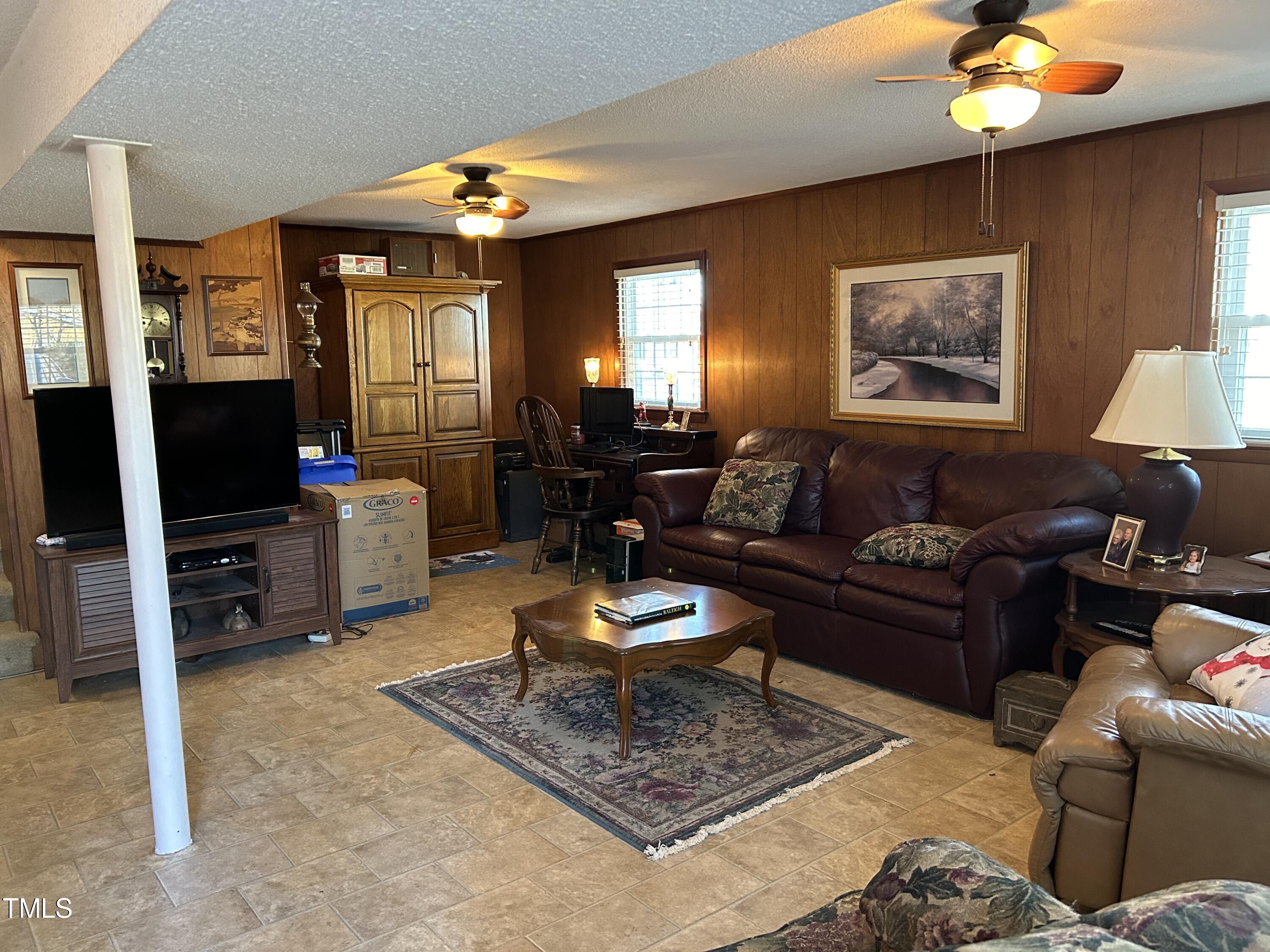 1320 North King Charles Road Raleigh, NC 27610 - Photo 21 of 21 a living room with furniture and a flat screen tv