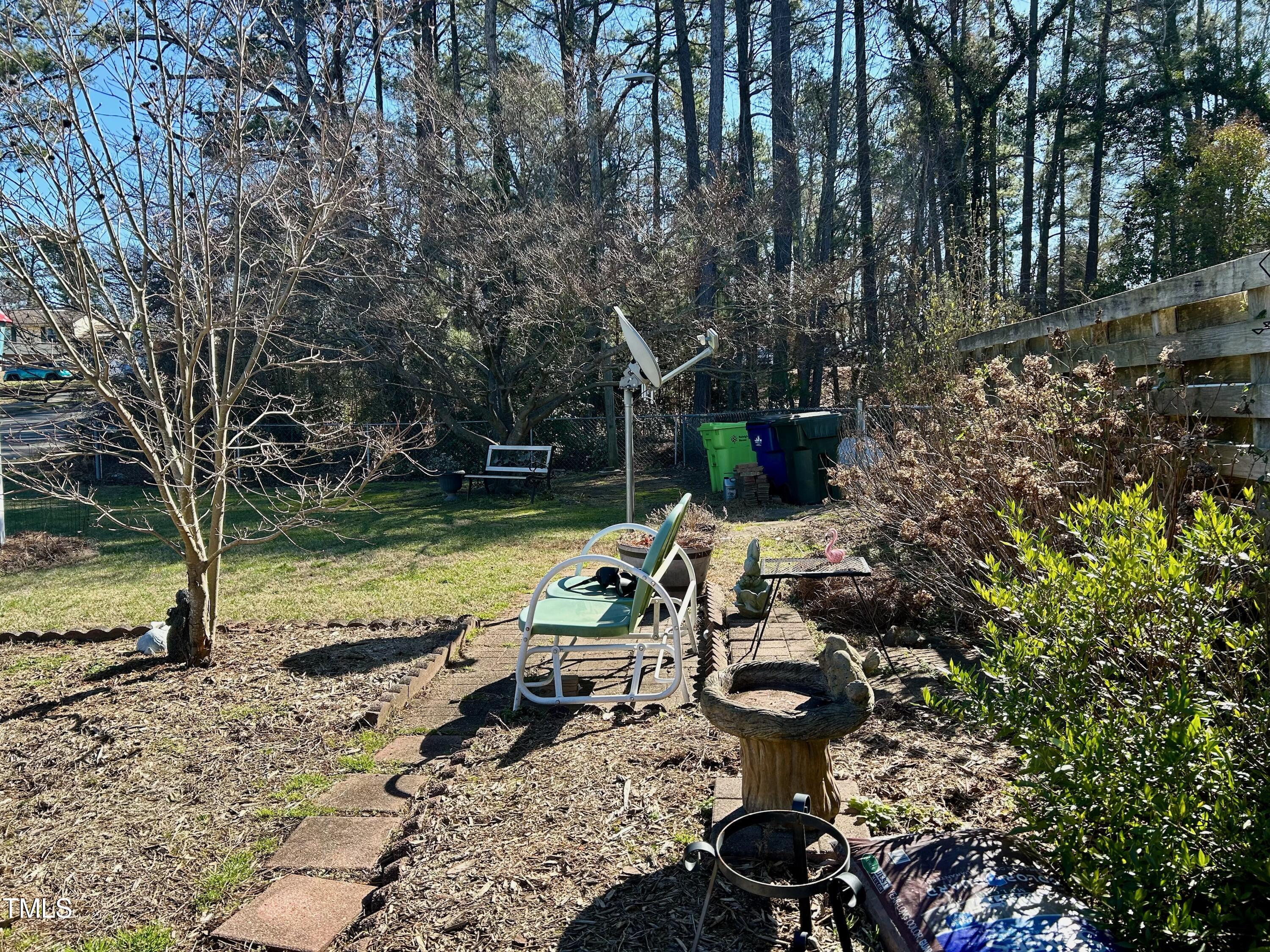 1320 North King Charles Road Raleigh, NC 27610 - Photo 4 of 21 a view of a backyard with chairs and potted plants