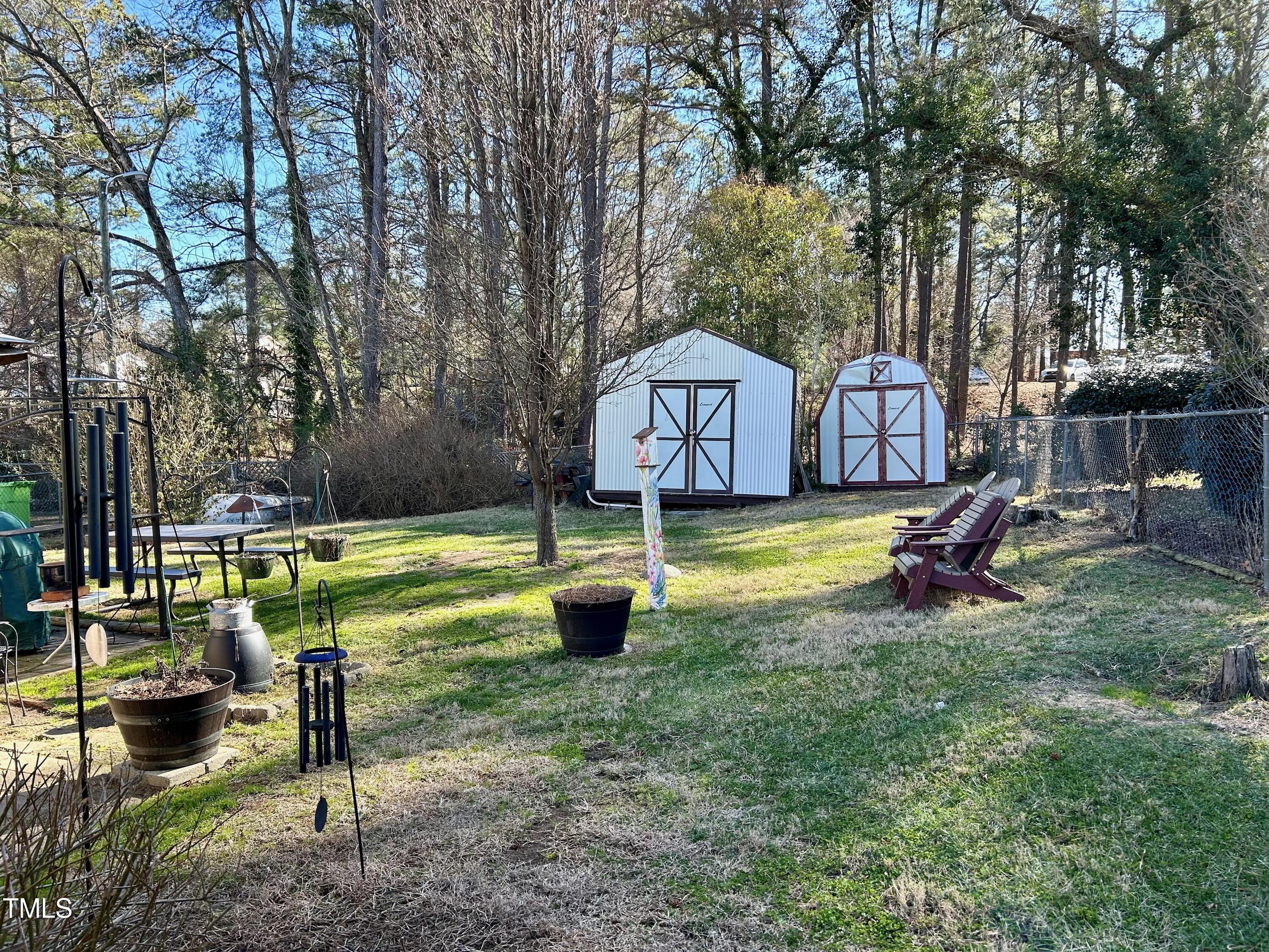 1320 North King Charles Road Raleigh, NC 27610 - Photo 6 of 21 a view of a fountain in a yard with palm tree