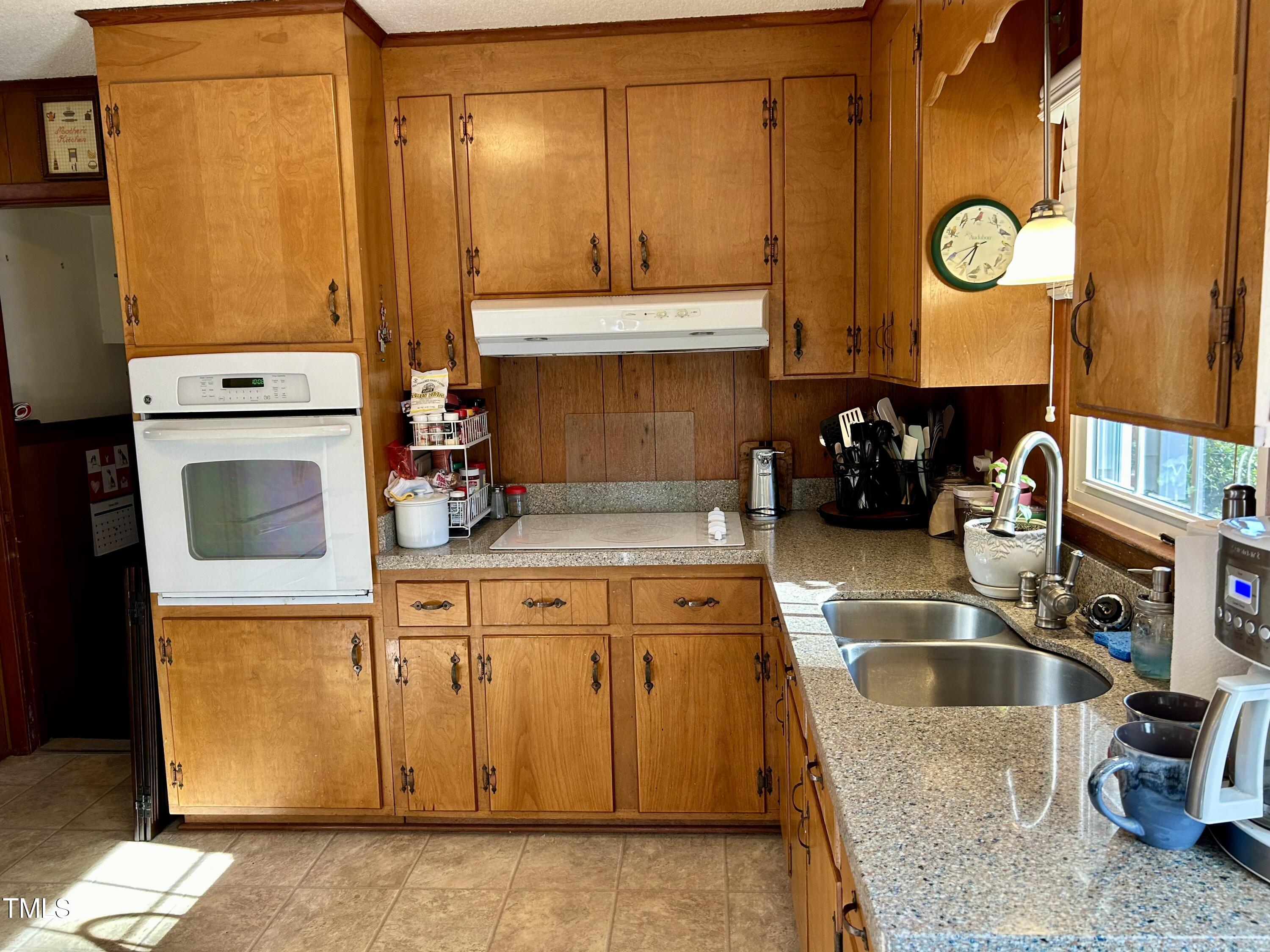 1320 North King Charles Road Raleigh, NC 27610 - Photo 10 of 21 a kitchen with sink cabinets and a clock