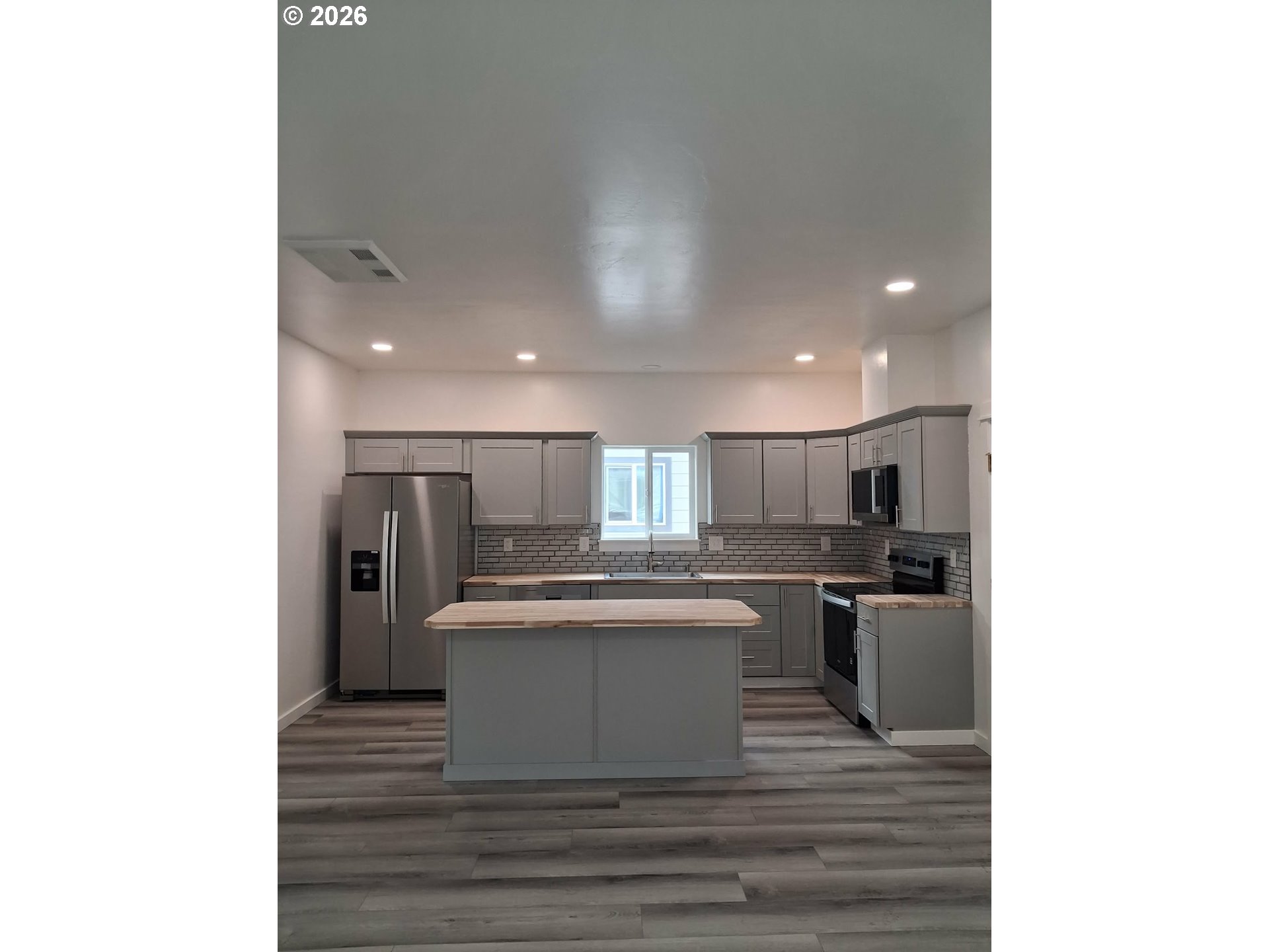 2008 True Loop La Grande, OR 97850 - Photo 3 of 16 a kitchen with stainless steel appliances kitchen island granite countertop a sink stove and refrigerator