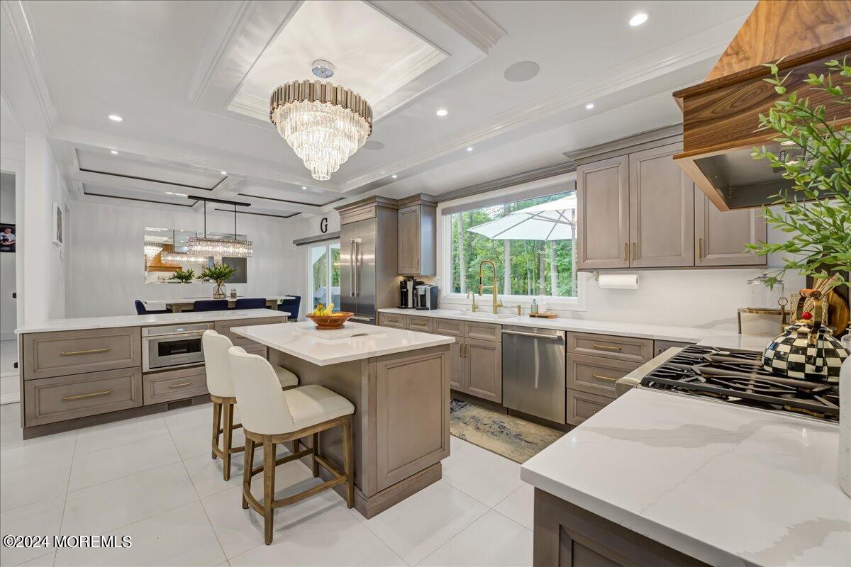 32 Devonshire Drive Morganville, NJ 07751 - Photo 17 of 53 a kitchen with a stove a window and chairs