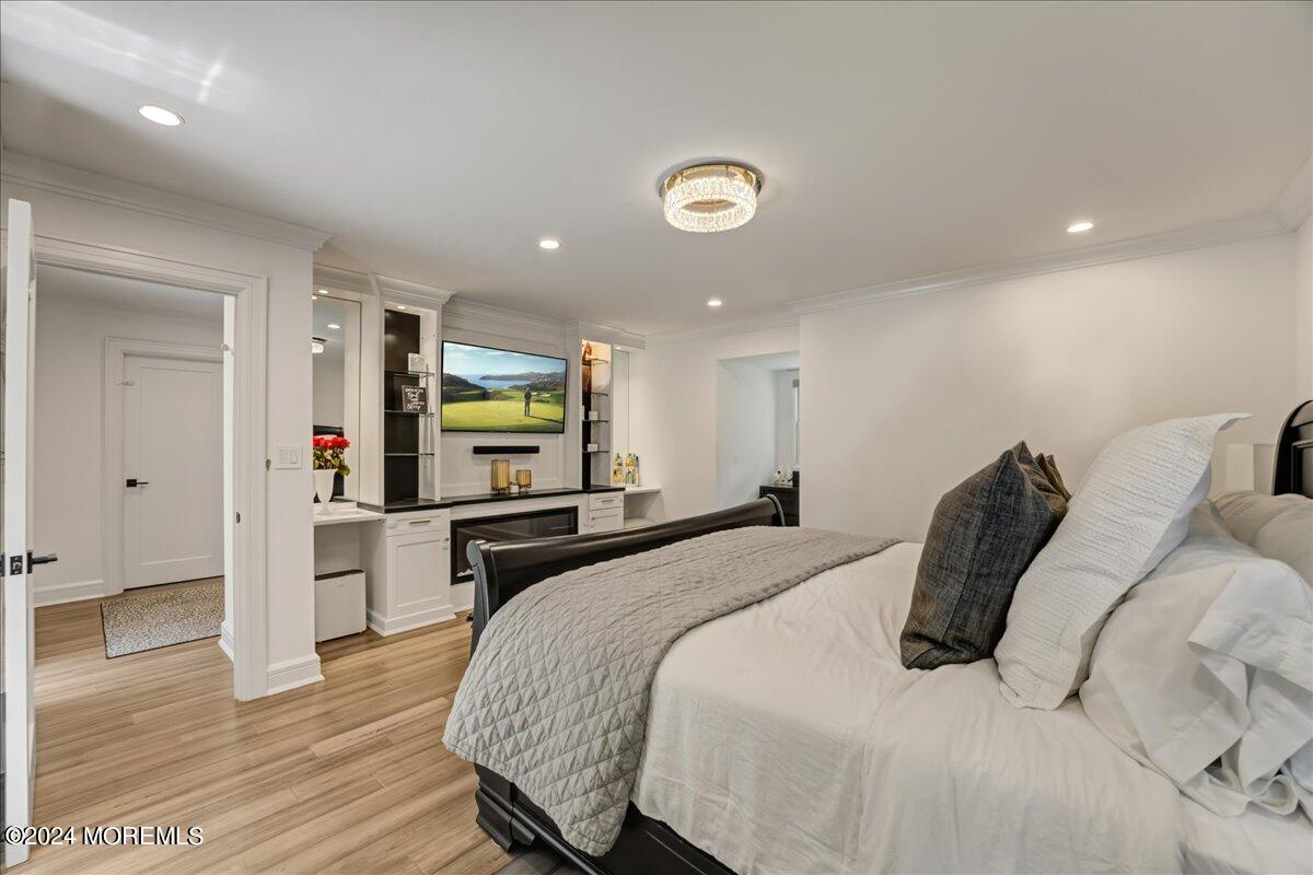 32 Devonshire Drive Morganville, NJ 07751 - Photo 27 of 53 a bedroom with a bed and a flat screen tv