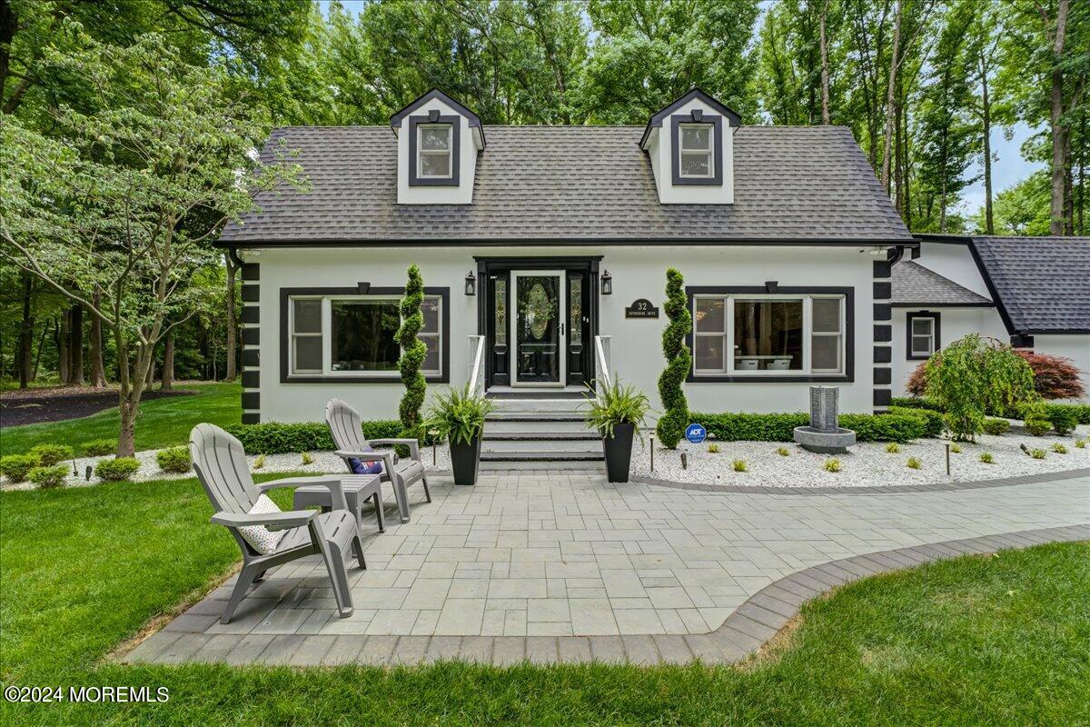 32 Devonshire Drive Morganville, NJ 07751 - Photo 3 of 53 a front view of a house with a garden and patio