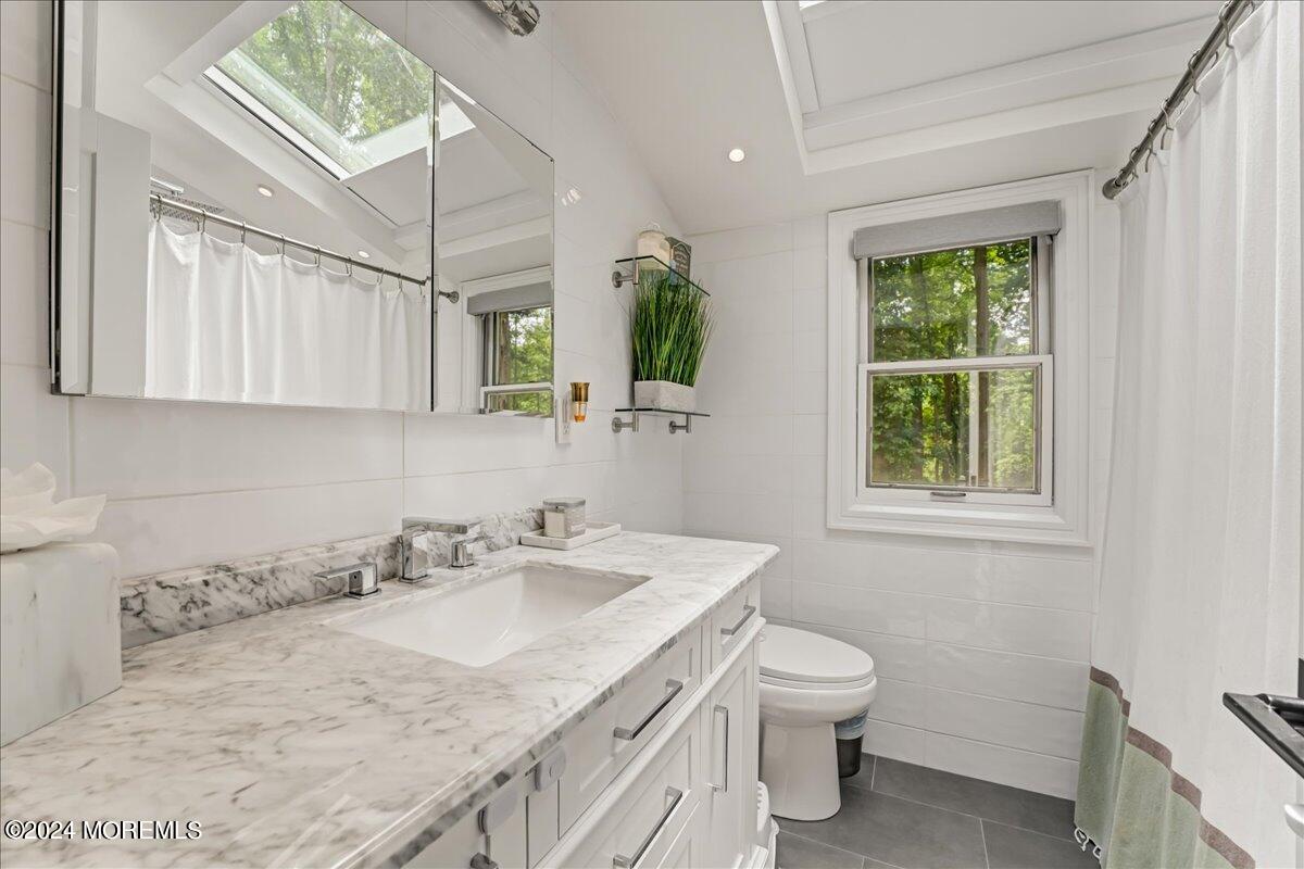 32 Devonshire Drive Morganville, NJ 07751 - Photo 32 of 53 a bathroom with a granite countertop sink toilet and a window