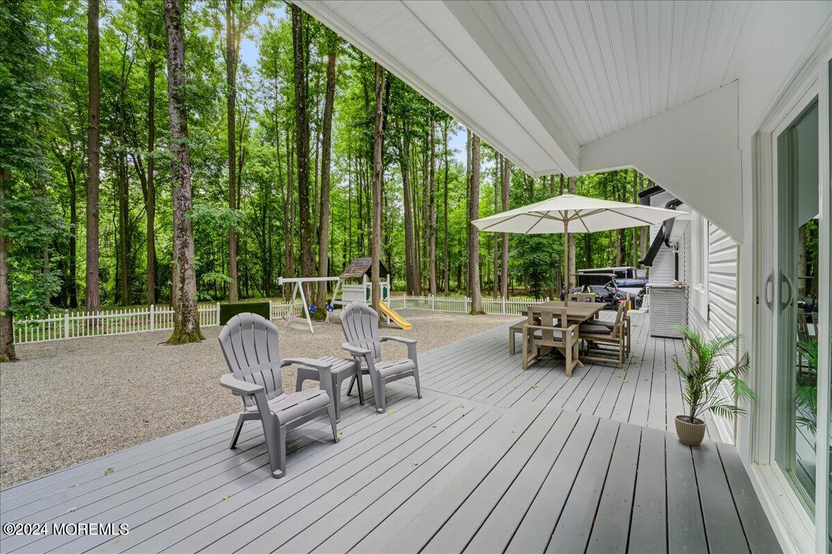 32 Devonshire Drive Morganville, NJ 07751 - Photo 39 of 53 a view of chairs and table in patio with wooden fence