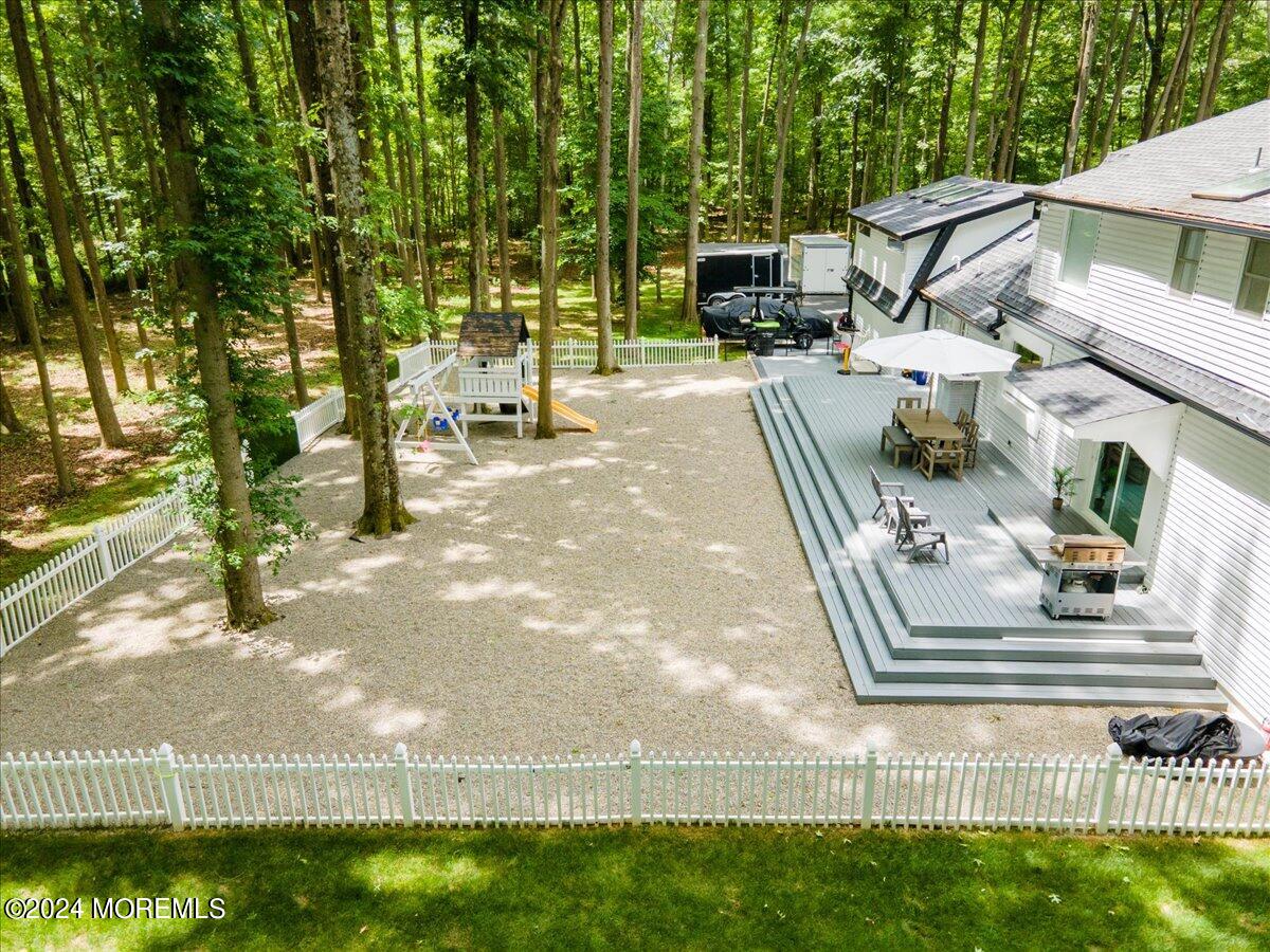 32 Devonshire Drive Morganville, NJ 07751 - Photo 49 of 53 a view of a patio with table and chairs and potted plants