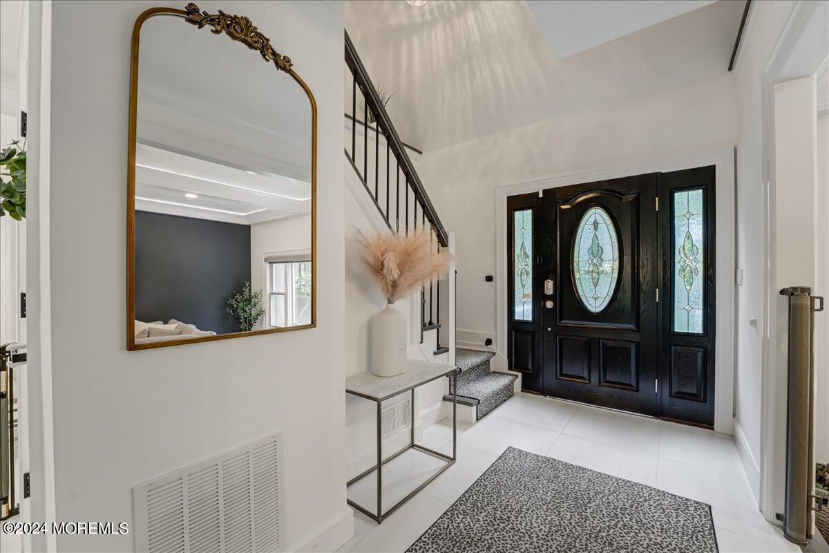 32 Devonshire Drive Morganville, NJ 07751 - Photo 7 of 53 a view of a hallway with entryway wooden floor and front door