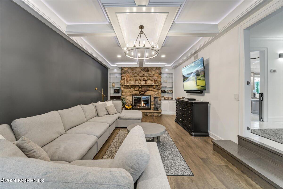 32 Devonshire Drive Morganville, NJ 07751 - Photo 10 of 53 a living room with furniture a chandelier and a flat screen tv