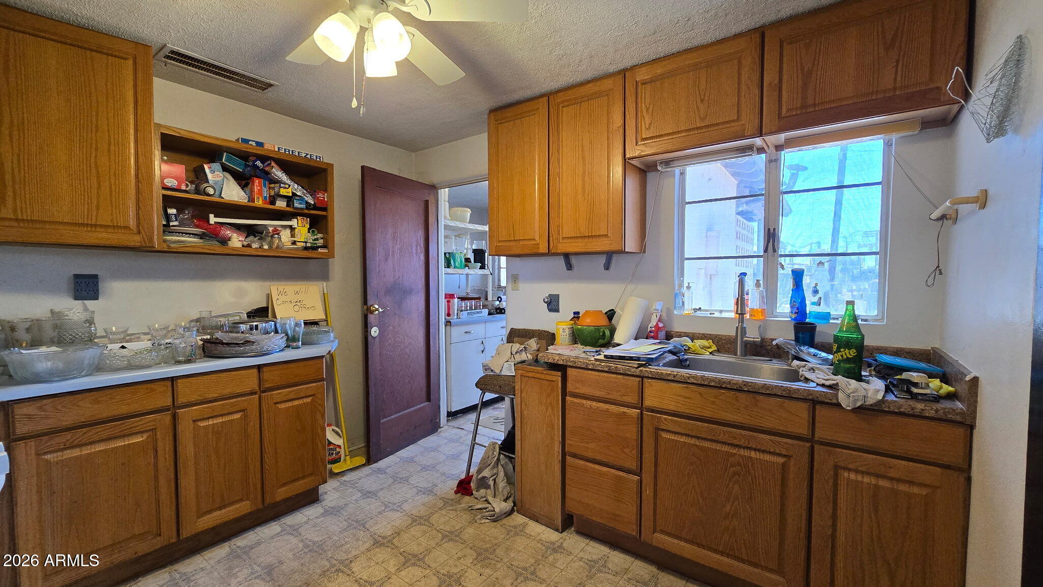 6803 South Miller Road Buckeye, AZ 85326 - Photo 7 of 50 a kitchen with sink cabinets and window