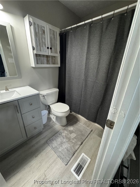 5733 Sagamore Road Hope Mills, NC 28348 - Photo 5 of 8 a bathroom with a granite countertop sink toilet and shower