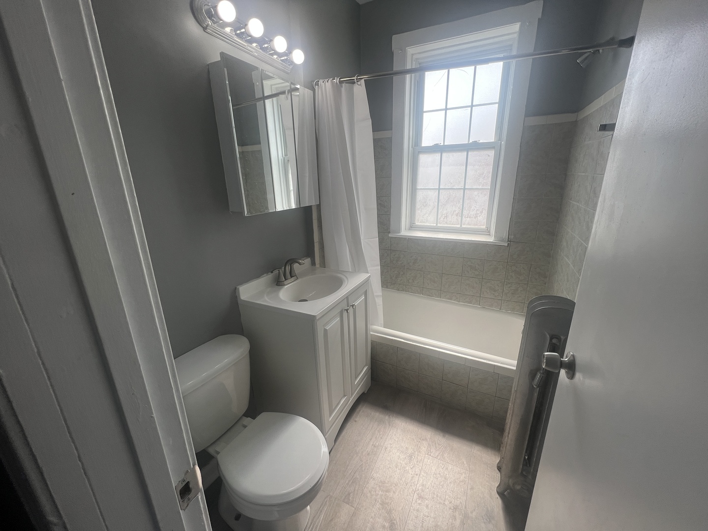 239 East 108th Street, Unit 2 Chicago, IL 60628 - Photo 7 of 7 a white toilet sitting next to a bathroom sink