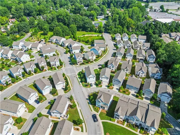 an aerial view of residential houses with outdoor space