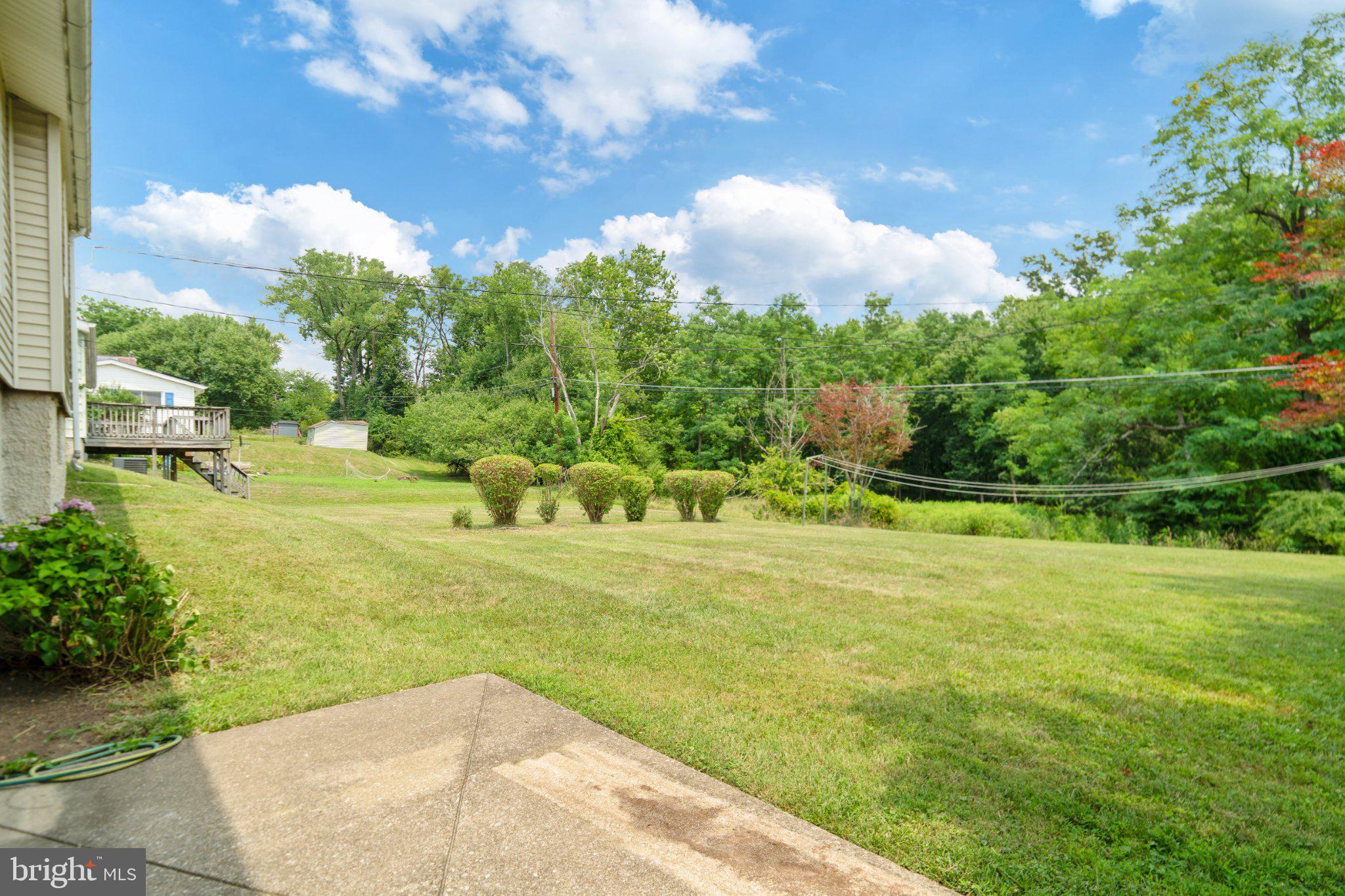 6812 Fox Meadow Road Baltimore, MD 21207 - Photo 5 of 27 Backyard with lush greenery.