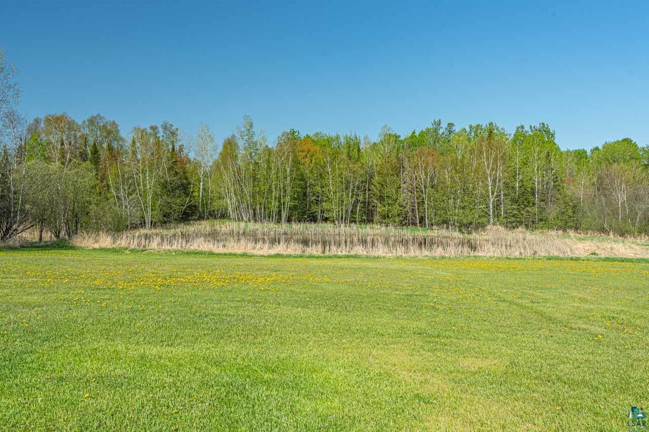 2581 O'Rourke Road Hibbing, MN 55746 - Photo 36 of 61 Expansive green lawn extending to a treeline with varied deciduous and evergreen trees