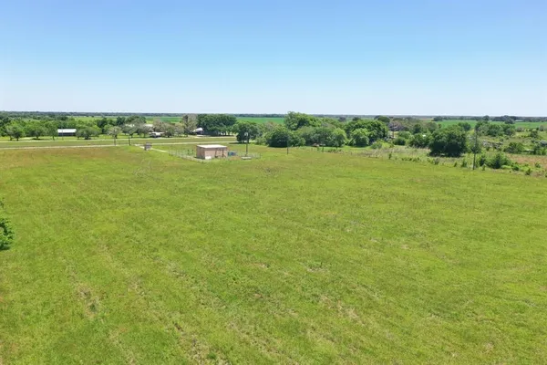 a view of a field with an ocean