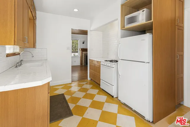 a kitchen with a cabinets and white appliances