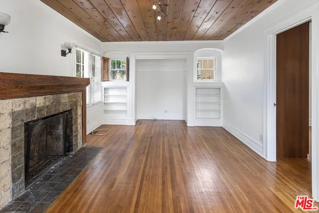 wooden floor in an empty room with a fireplace